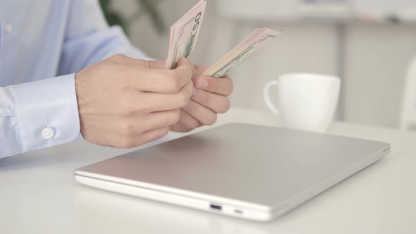 Close Up of Hand Counting Dollar