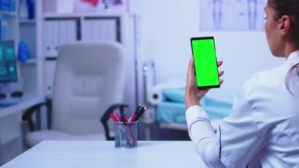 Chroma Key Display on Smartphone Used By Doctor