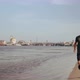 Muscular Young Man Running on the Beach in the City on a Sunny Day - VideoHive Item for Sale