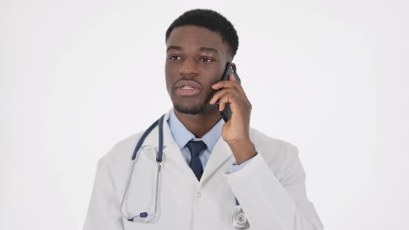 African Doctor Talking on Phone on White Background