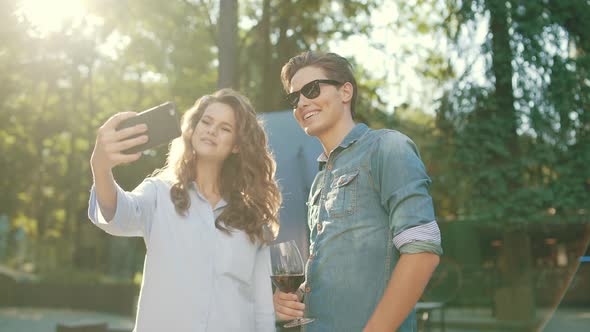 Happy Couple Taking Photos And Having Fun In Nature On Weekend