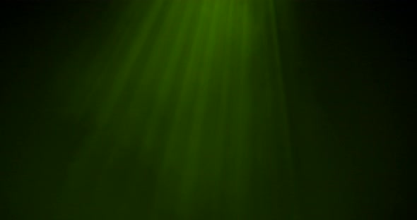 Light rays shining from above coming through deep green water