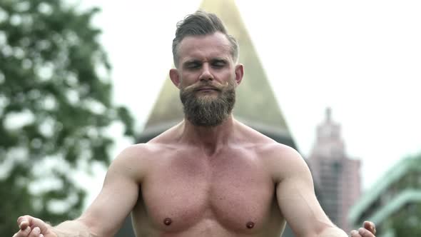 Shirtless Bearded Man with Eyes Closed on a Yoga Position