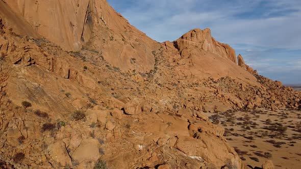 Drone span along the side of a rocky mountain Erongo in Namibia, desert