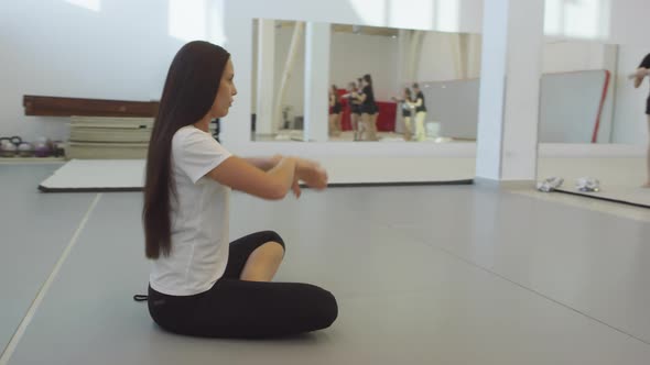 Young Woman Coaching Girls at Cheerleading Practice