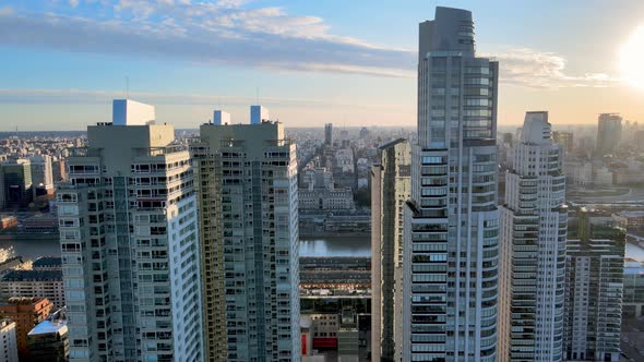 Modern high-rise apartment buildings on the Rio de la Plata riverbank. Aerial cityscape during sunse