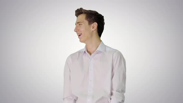 Handsome Young Man Laughing Out Loud on Gradient Background