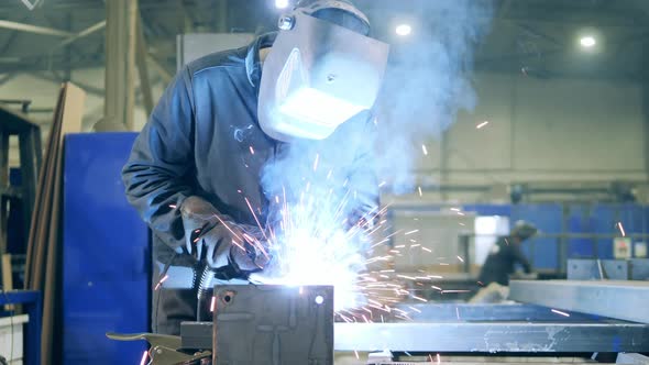 Professional Welder Working at Factory Facility. Welding Technician in Safety Wear at Work 