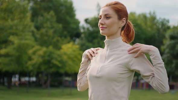 Caucasian fitness woman training warming up oudoors.