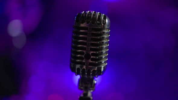 Closeup Black Microphone with Night Club Lights at Background