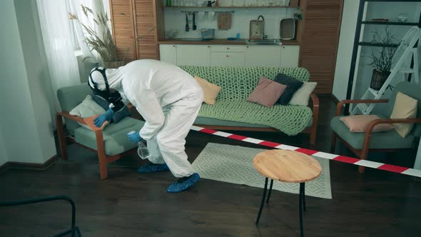 Worker Wipes Furniture in a Room During Pandemic
