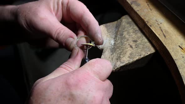Closeup of Wedding Ring Polishing By Caicasian Jeweler Isolated  Footage