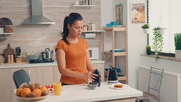 Cheerful Wife Grinding Coffee Beans