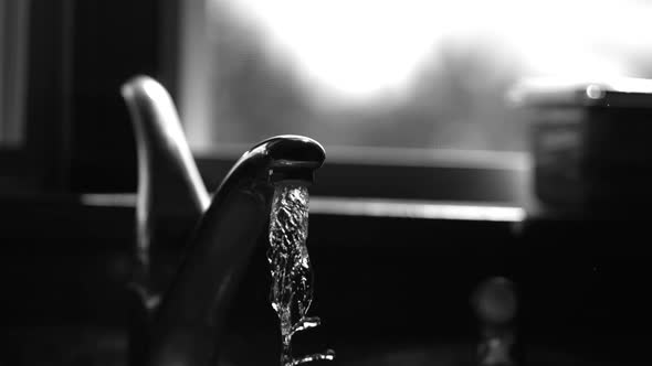 Water pouring from a faucet in ultra slow motion 1500fps on a reflective surface - WATER FAUCET 