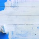 Hand of a Male Painter Paints a Blue Boards Wall Into the White Color with a Paintbrush - VideoHive Item for Sale
