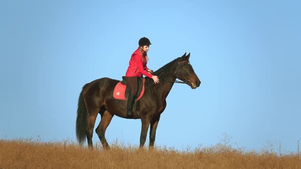 Woman on a Horse Outdoors in the Field