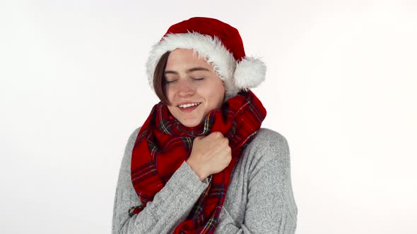 Happy Woman Wearing Christmas Hat and Winter Scarf Smiling To the Camera