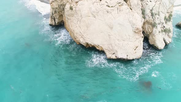 Aerial Top View of Cliff Rocks in a Blue Ocean