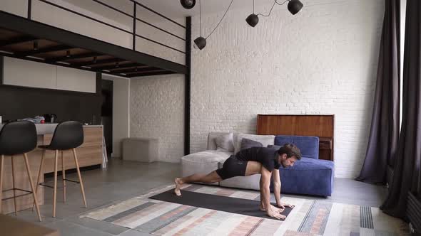 Caucasian Man Practicing Yoga or Stretching on Mat at Home