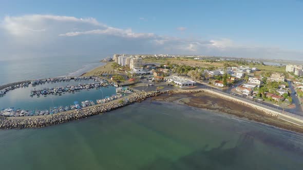 Aerial shot over Larnaca marina in Cyprus, resort town, port with yachts