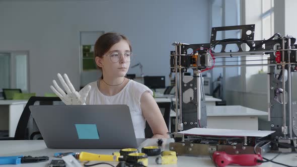 School Girl Writes the Notes About 3D Printed Hand