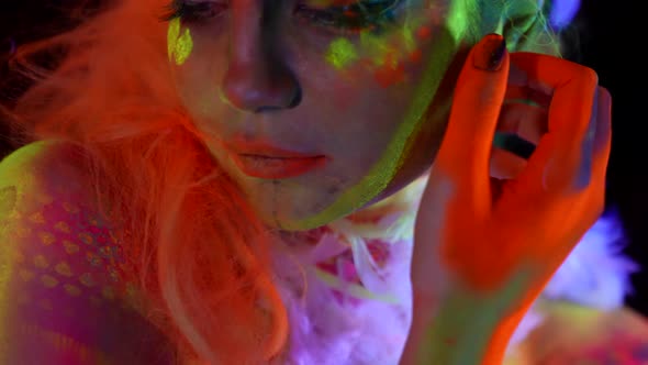 Body Art By Fluorescent Paints on Face and Body of Attractive Woman Extravagant Image