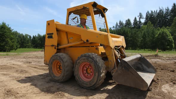 Construction worker driving excavation equipment