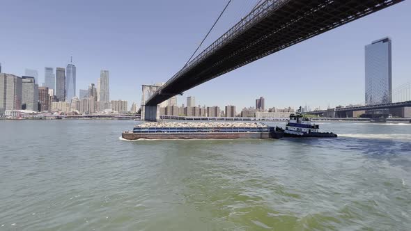 Solid waste management by barge and tugboat in New York, Brooklyn Bridge; aerial