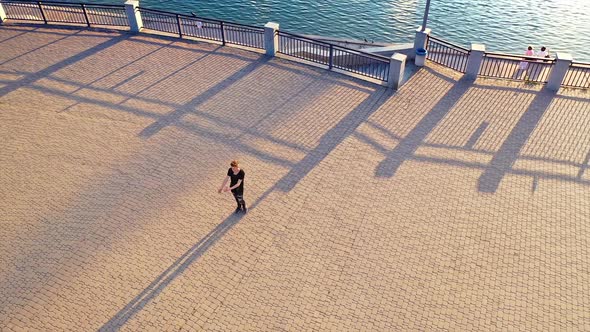 Dancer performing modern dance. Aerial view of young man dancing in the street