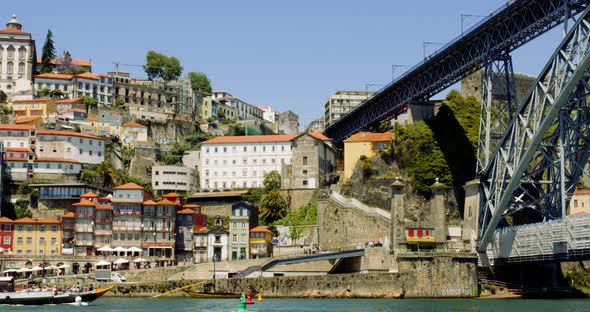 Central Porto Boats passing under Luís I Bridge with Crowd in Background, Portugal 4K CINEMATIC SUMM