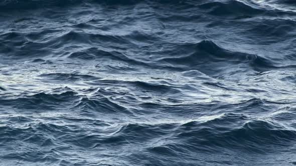 Sea Waving During Light Storm. Day Light Reflecting on Water Surface. Blue Waves Rolling. Slow