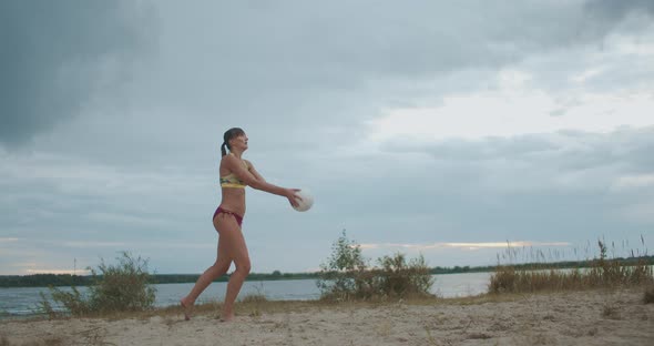 Active Sportswoman Is Playing Beach Volleyball, Young and Slender Athlete Is Striking Ball, Slow