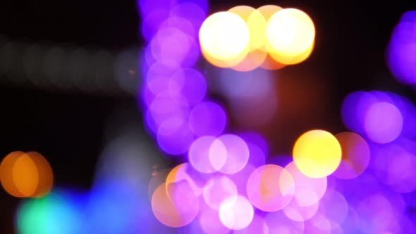 Closeup of Blurred Trees Decorated with Lights on the Street at Christmas