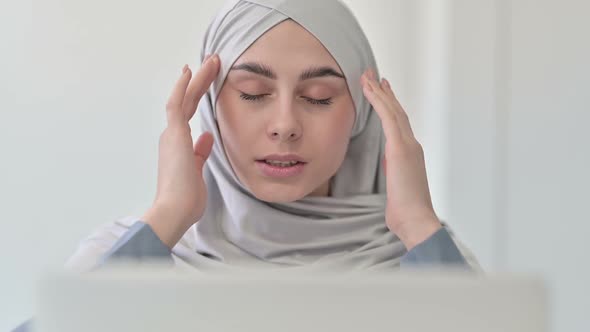 Arab Woman with Laptop Having Headache