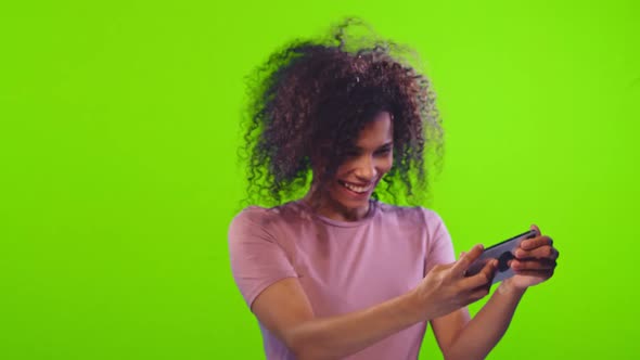 Chroma Key Footage of a Dark-skinned Curly Woman Plays Games Online