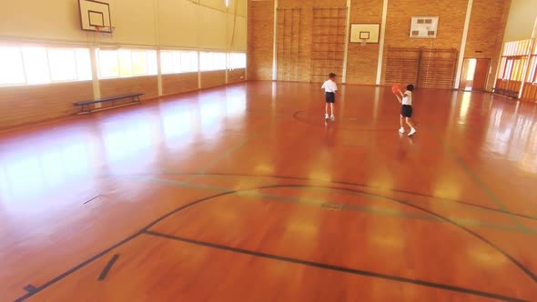 Boys playing basketball in court