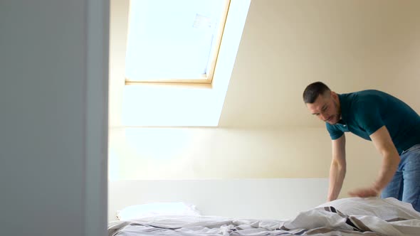 Happy Man Making Bed at Home 