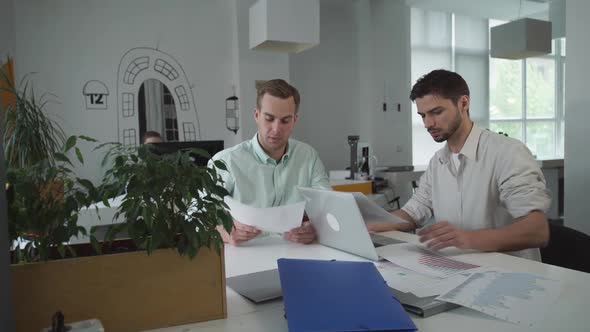 Happy Professional Workers in Modern Office.