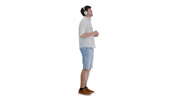 Casual Young Man in Headphones Listening To Music and Enjoying It on White Background