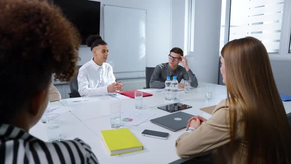 Businesswoman Discussing Company Progress with Colleagues