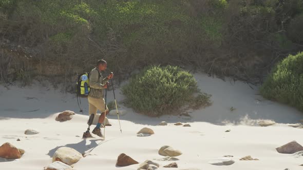 Sporty mixed race man with prosthetic leg hiking