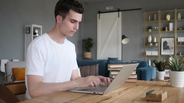 Young Man Working On Laptop