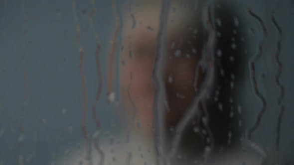 Miserable Old Lady Looking in Rainy Window and Crying, Loneliness and Depression