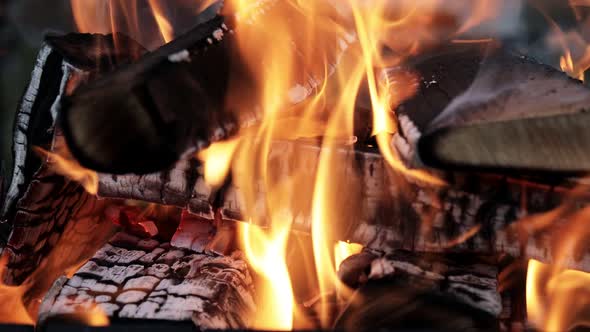 Coals are burning in the grill, the fire transforms the wood into charcoal