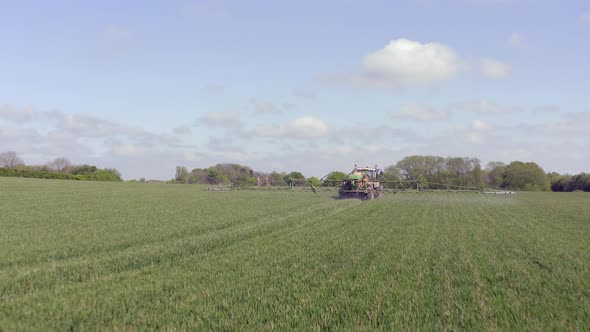 Tractor Spraying a Controversial Glyphosate Herbicide on Agricultural Land