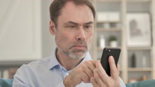 Senior Aged Businessman Using Smartphone, Typing Message