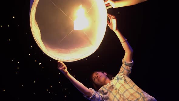 Asian Woman Releases A Sky Lantern