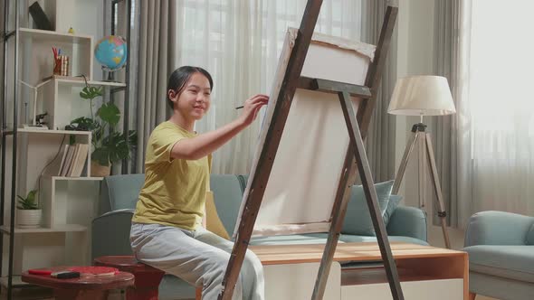 Asian Artist Girl Holding Paintbrush Mixed Color And Thinking Before Painting On The Canvas