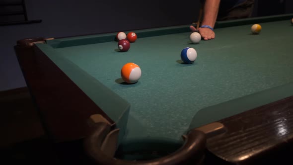 Billiard balls with numbers on a pool table. Playing pool billiards in a night bar