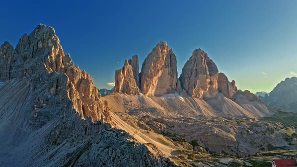 Mountain shelter Dreizinnen Hut and Tre Cime at sunset